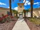 Inviting clubhouse entrance featuring an arched entryway, lush landscaping, and a well-maintained walkway at 5125 Palm Springs Blvd # 3108, Tampa, FL 33647
