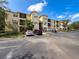 Exterior view of the condo building with well-maintained grounds and ample parking at 5125 Palm Springs Blvd # 3108, Tampa, FL 33647