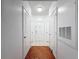 Neutral hallway featuring hardwood floors and multiple doors leading to various rooms in the unit at 5125 Palm Springs Blvd # 3108, Tampa, FL 33647