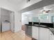 Bright kitchen with a laundry closet featuring a washer and dryer at 5125 Palm Springs Blvd # 3108, Tampa, FL 33647