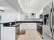 Well-equipped kitchen with granite countertops, modern appliances, and tile flooring at 5125 Palm Springs Blvd # 3108, Tampa, FL 33647