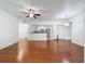 Expansive living room showcasing hardwood floors, a ceiling fan, and an open layout to the kitchen at 5125 Palm Springs Blvd # 3108, Tampa, FL 33647
