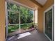Enclosed patio with a screened door and a view of the lush backyard at 5125 Palm Springs Blvd # 3108, Tampa, FL 33647