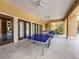 Covered patio with a ping pong table offers a recreational area for entertainment and fun at 5125 Palm Springs Blvd # 3108, Tampa, FL 33647