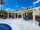 Outdoor poolside pergola with tables and seating provides a charming space for social gatherings and relaxation at 5125 Palm Springs Blvd # 3108, Tampa, FL 33647