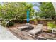 Serene backyard setting with a deck, loungers, and a shade umbrella, perfect for relaxation and outdoor enjoyment at 549 39Th Ne Ave, St Petersburg, FL 33703