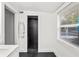 Bathroom featuring shower with gray tile and a window with a pool view at 549 39Th Ne Ave, St Petersburg, FL 33703
