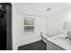 Bathroom with white marble vanity, dark tile floors, toilet, and large shower at 549 39Th Ne Ave, St Petersburg, FL 33703