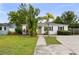 Charming bungalow featuring a well-maintained lawn, lush greenery, and a welcoming front entrance at 549 39Th Ne Ave, St Petersburg, FL 33703