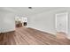 Living room with hardwood floors, white paint, view to fireplace and dining room at 549 39Th Ne Ave, St Petersburg, FL 33703