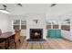 Bright living room featuring a cozy fireplace and an adjacent dining area with wood floors at 549 39Th Ne Ave, St Petersburg, FL 33703