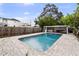A well-maintained pool surrounded by stone pavers with an adjacent cabana and a lush green landscape at 549 39Th Ne Ave, St Petersburg, FL 33703