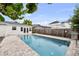 Relaxing backyard pool featuring stone pavers and lush landscaping, offering a private retreat and an outdoor living experience at 549 39Th Ne Ave, St Petersburg, FL 33703