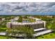 Beautiful aerial view of a lakeside condominium community with lush landscaping and covered parking at 6190 80Th N St # 310, St Petersburg, FL 33709