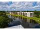 Community buildings set along a beautiful lake, with lush greenery, offering a tranquil setting at 6190 80Th N St # 310, St Petersburg, FL 33709