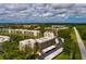 Serene aerial view of lakeside condominiums surrounded by trees and offering covered parking at 6190 80Th N St # 310, St Petersburg, FL 33709