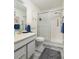 Bathroom featuring a glass-enclosed shower, a sink with storage, and a grey wood-look floor at 6190 80Th N St # 310, St Petersburg, FL 33709