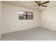 Bedroom with neutral carpeting, a ceiling fan, and a large window with blinds at 6190 80Th N St # 310, St Petersburg, FL 33709