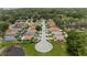 Overhead view of a serene residential neighborhood featuring lush greenery and a peaceful pond at 7509 E 26Th Ave, Tampa, FL 33619