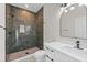 Bathroom features a tiled walk-in shower, quartz countertop vanity, and modern finishes at 7509 E 26Th Ave, Tampa, FL 33619
