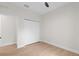 Bright bedroom featuring wood-look flooring and a closet, providing a comfortable and functional space at 7509 E 26Th Ave, Tampa, FL 33619