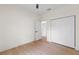 Bright bedroom featuring wood-look flooring and a closet, providing a comfortable and functional space at 7509 E 26Th Ave, Tampa, FL 33619