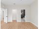 Bright bedroom features wood-look flooring, with ensuite bathroom featuring a tiled walk-in shower at 7509 E 26Th Ave, Tampa, FL 33619