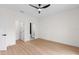 Bright bedroom features wood-look flooring, contemporary ceiling fan, and ensuite bathroom at 7509 E 26Th Ave, Tampa, FL 33619