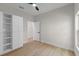 Bedroom features built in wardrobe, wood-look floors, contemporary ceiling fan, and natural light at 7509 E 26Th Ave, Tampa, FL 33619