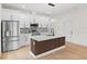 Bright kitchen features stainless steel appliances, island with seating, and stylish backsplash at 7509 E 26Th Ave, Tampa, FL 33619