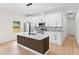 Bright kitchen features stainless steel appliances, island with seating, and stylish backsplash at 7509 E 26Th Ave, Tampa, FL 33619