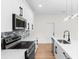 Bright kitchen features stainless steel appliances and stone backsplash at 7509 E 26Th Ave, Tampa, FL 33619