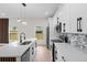 Bright kitchen features stainless steel appliances, island with seating, and stylish backsplash at 7509 E 26Th Ave, Tampa, FL 33619