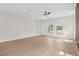 Open living space with light hardwood floors, modern ceiling fan and large windows at 7509 E 26Th Ave, Tampa, FL 33619