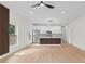 Open living and kitchen space featuring light wood floors and stainless steel appliances at 7509 E 26Th Ave, Tampa, FL 33619