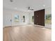 Large living room with wood-look floors, recessed lighting and large windows at 7509 E 26Th Ave, Tampa, FL 33619