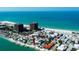 Scenic view of beach town with colorful homes, private beaches, docks, and turquoise waters on a clear, sunny day at 7777 Bayshore Dr, Treasure Island, FL 33706