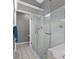 Contemporary bathroom featuring glass enclosed shower with a safety bar and tiled floor at 8441 Danbury Ln, Hudson, FL 34667