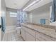 Bathroom featuring a tiled shower/tub, a granite vanity and a full mirror at 8441 Danbury Ln, Hudson, FL 34667