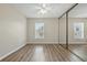 This is a spacious bedroom with hardwood floors, and large closet with mirrored doors at 8441 Danbury Ln, Hudson, FL 34667