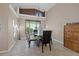 Dining room with large window, modern light fixture, and neutral wall color at 8441 Danbury Ln, Hudson, FL 34667