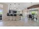 Open kitchen featuring a breakfast bar with seating, modern appliances, and stylish pendant lighting at 8441 Danbury Ln, Hudson, FL 34667