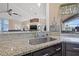 Bright kitchen boasts granite countertops, stainless steel sink, and seamless pass through to the patio at 8441 Danbury Ln, Hudson, FL 34667