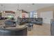 Open-concept living room features neutral tones, tile flooring, and comfortable seating at 8441 Danbury Ln, Hudson, FL 34667