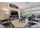 Open living room with modern fireplace, large television, and sliding glass doors to outdoor pool at 8441 Danbury Ln, Hudson, FL 34667