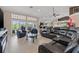 Spacious living room featuring a large sectional, tile flooring, and bright natural light at 8441 Danbury Ln, Hudson, FL 34667