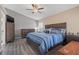 Comfortable bedroom with ceiling fan, wood-look floors, and neutral wall paint at 8441 Danbury Ln, Hudson, FL 34667