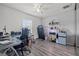 A functional office with a glass desk and space for a treadmill and mini refrigerator at 8441 Danbury Ln, Hudson, FL 34667