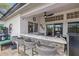 Outdoor bar area with seating, outdoor kitchen and pass through window to inside area at 8441 Danbury Ln, Hudson, FL 34667