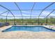 A refreshing screened-in pool with brick pavers offers outdoor relaxation and privacy at 8441 Danbury Ln, Hudson, FL 34667